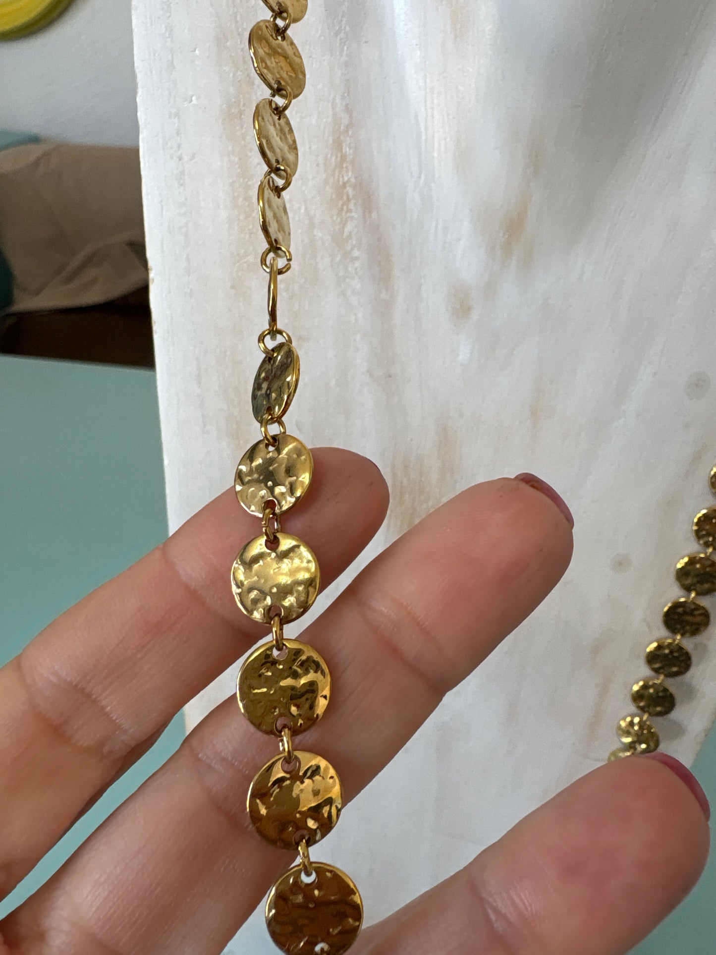 Gold coloured long disc necklace