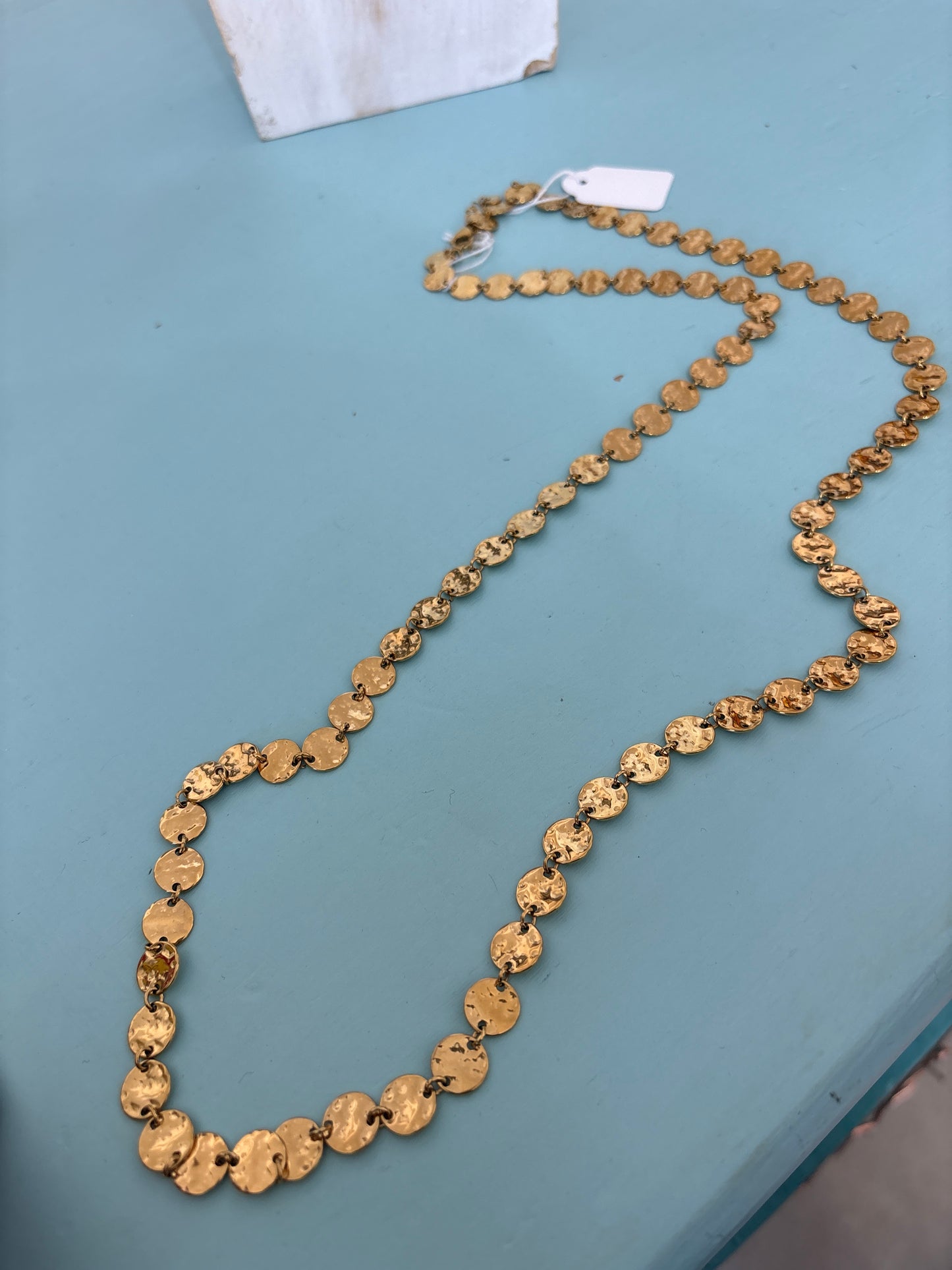 Gold coloured long disc necklace